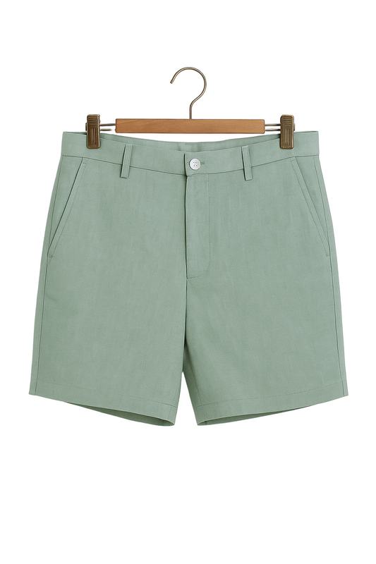 Sage green shorts on a hanger against a white background